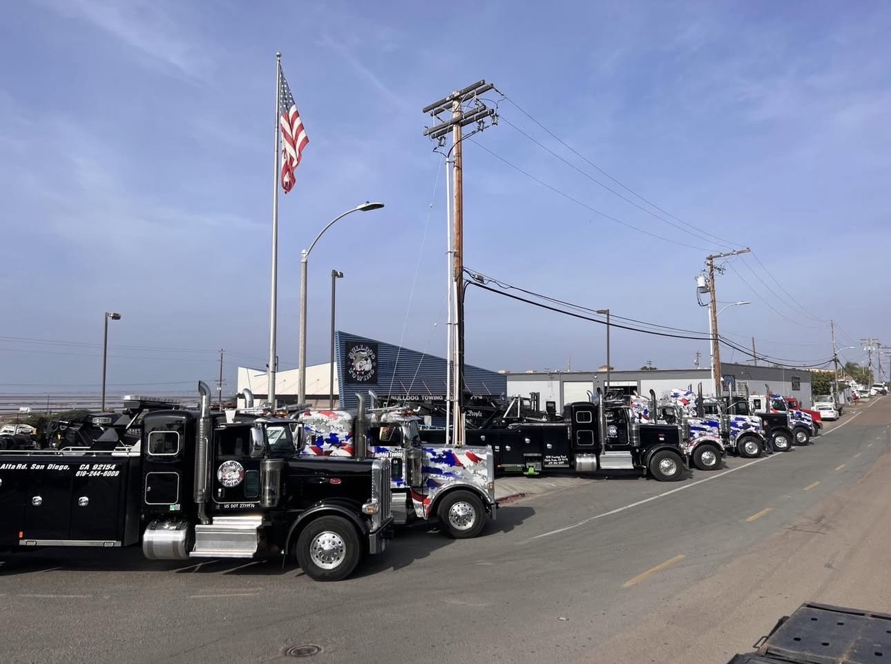 Bulldog Towing heavy-duty tow trucks lined up at the San Diego yard, showcasing the company’s large-capacity recovery and transport fleet.